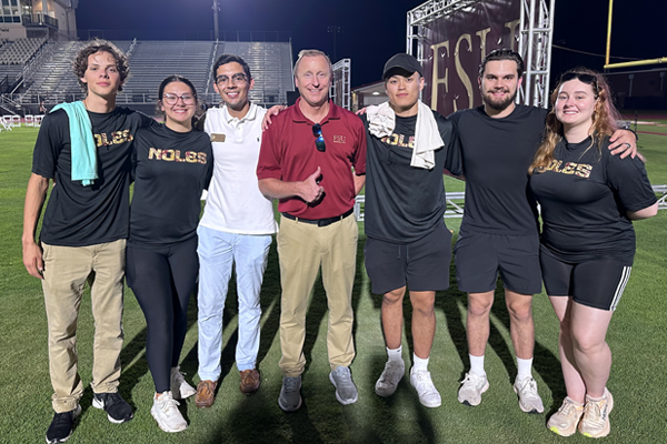 Jim Allen with student volunteers at the 2024 Commencement Ceremony