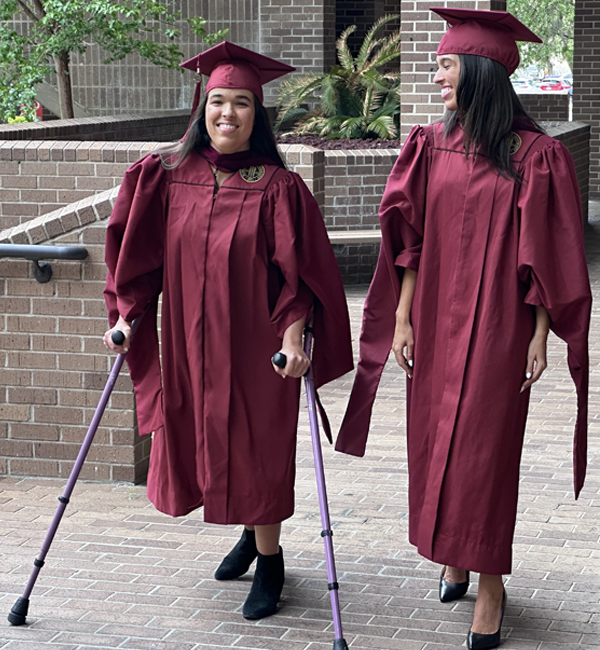 sisters Hallie and Sydney Pellerin in graduation robes