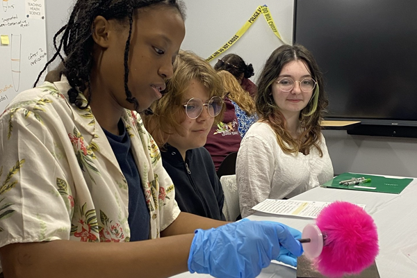 young students learn about dusting for latent prints