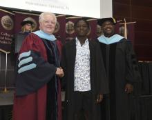 Student robed, then signs Freshmen Book