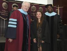 Student robed, then signs Freshmen Book