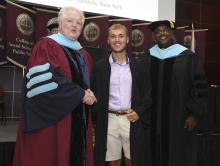 Student robed, then signs Freshmen Book