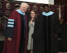 Student robed, then signs Freshmen Book