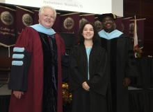 Student robed, then signs Freshmen Book