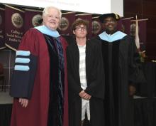 Student robed, then signs Freshmen Book