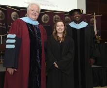 Student robed, then signs Freshmen Book