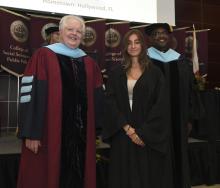 Student robed, then signs Freshmen Book