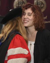 Student robed, then signs Freshmen Book