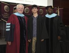 Student robed, then signs Freshmen Book