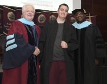 Student robed, then signs Freshmen Book