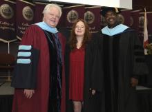 Student robed, then signs Freshmen Book