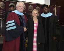 Student robed, then signs Freshmen Book