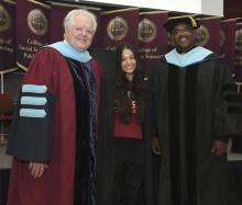 Student robed, then signs Freshmen Book