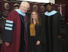 Student robed, then signs Freshmen Book
