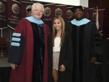 Student robed, then signs Freshmen Book