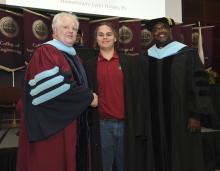 Student robed, then signs Freshmen Book