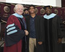 Student robed, then signs Freshmen Book