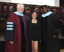 Student robed, then signs Freshmen Book