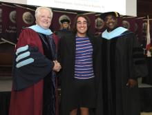 Student robed, then signs Freshmen Book