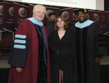 Student robed, then signs Freshmen Book