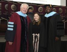 Student robed, then signs Freshmen Book