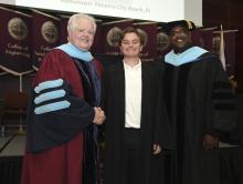 Student robed, then signs Freshmen Book