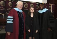 Student robed, then signs Freshmen Book