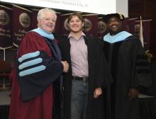 Student robed, then signs Freshmen Book