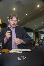 Student robed, then signs Freshmen Book