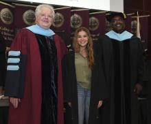 Student robed, then signs Freshmen Book