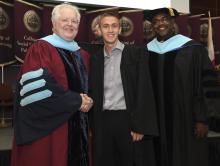 Student robed, then signs Freshmen Book