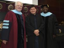 Student robed, then signs Freshmen Book