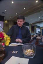 Student robed, then signs Freshmen Book