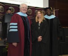 Student robed, then signs Freshmen Book