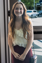 Lady arriving at Holley glass doors 1