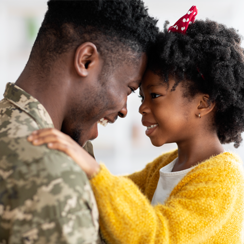 "male soldier looking at child"