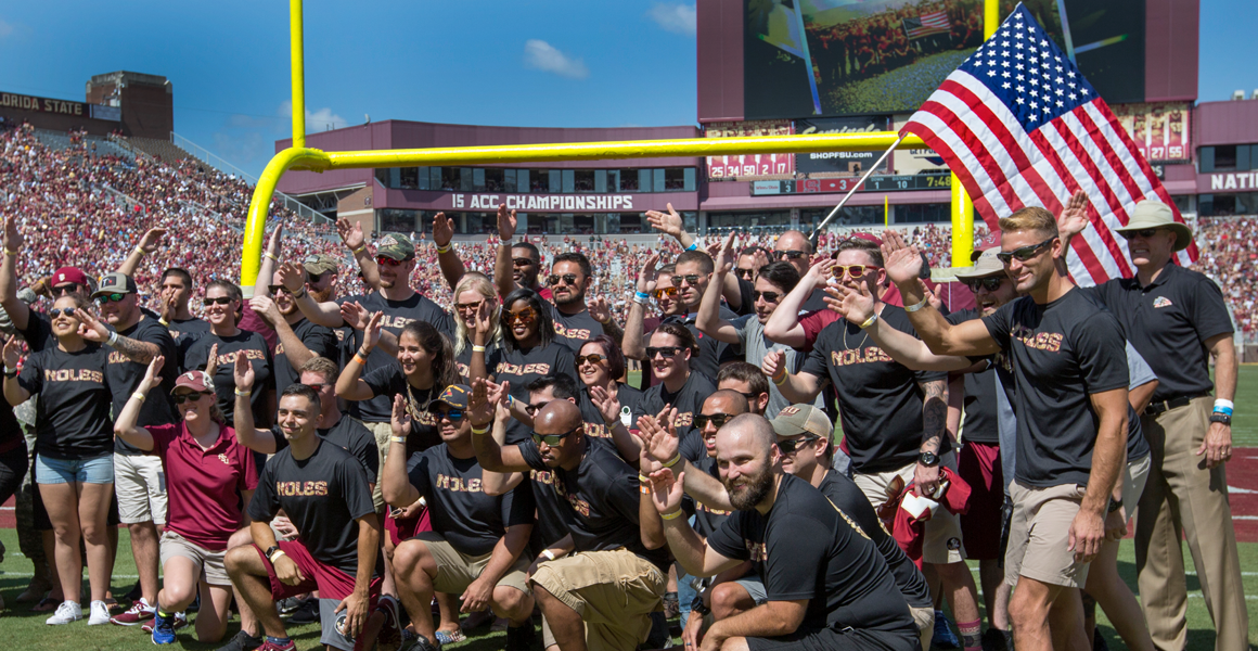"students at FSU game doing the fsu chop"
